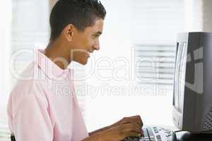 Teenage Boy Using Desktop Computer