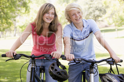 Teenage Boy And Girl On Bicycles