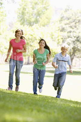 Teenagers Running Through Park