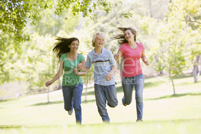 Teenagers Running Through Park