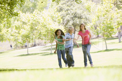 Teenagers Running Through Park