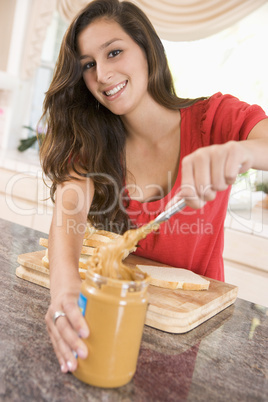 Teenage Girl Making Peanut Butter Sandwich