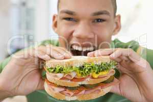 Teenage Boy Eating Sandwich