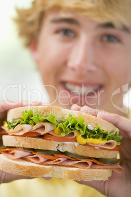 Teenage Boy Eating Sandwich