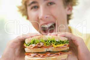 Teenage Boy Eating Sandwich