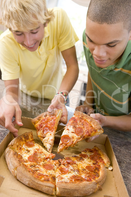 Teenage Boys Eating Pizza