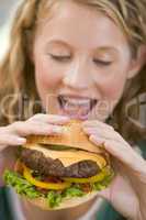 Teenage Girl Eating Burgers