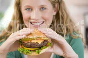 Teenage Girl Eating Burgers