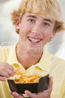 Teenage Boy Eating French Fries