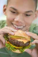 Teenage Boy Eating Burger