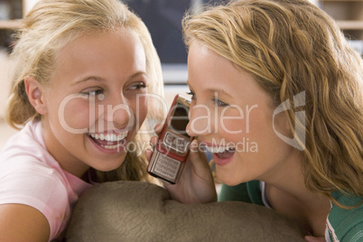 Teenagers Hanging Out In Front Of Television Using Mobile Phones