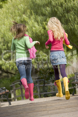 Pair Of Teenage Girls Jogging In Park