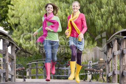 Pair Of Teenage Girls Jogging In Park