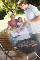 Family Enjoying A Barbeque