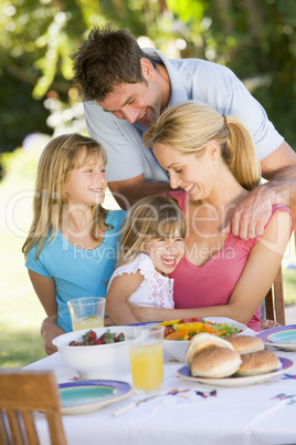 Family Enjoying A Barbeque