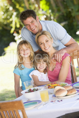 Family Enjoying A Barbeque