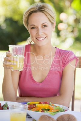 Woman Enjoying A Salad In A Garden