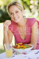 Woman Enjoying A Salad In A Garden