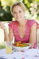 Woman Enjoying A Salad In A Garden