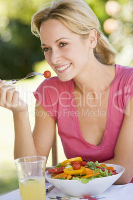 Woman Enjoying A Salad In A Garden