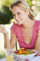 Woman Enjoying A Salad In A Garden