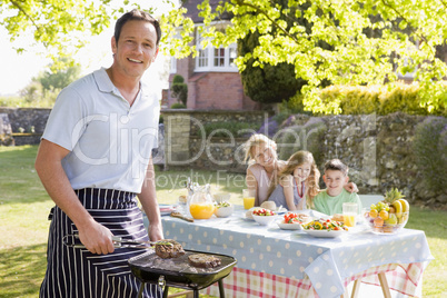 Family Enjoying A Barbeque