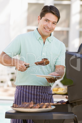 Man Barbequing In A Garden