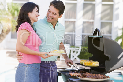 Couple Cooking On A Barbeque