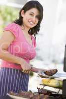 Woman Cooking On A Barbeque