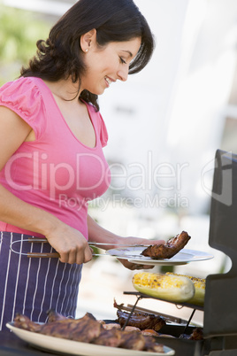 Woman Cooking On A Barbeque