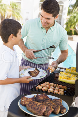 Father And Son Barbequing