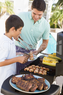 Father And Son Barbequing