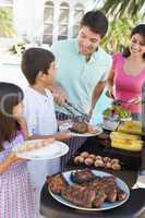 Family Enjoying A Barbeque