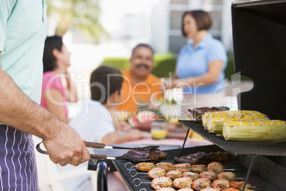 Family Enjoying A Barbeque