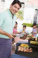 Family Enjoying A Barbeque