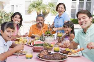 Family Enjoying A Barbeque