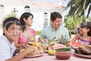 Family Enjoying A Barbeque