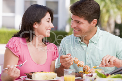 Family Enjoying A Barbeque