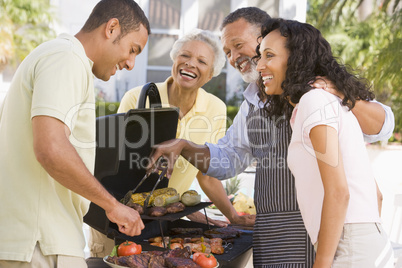 Family Enjoying A Barbeque