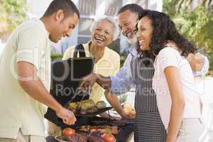 Family Enjoying A Barbeque