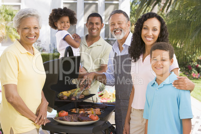 Family Enjoying A Barbeque