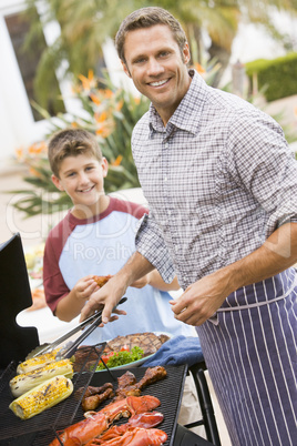 Father And Son Barbequing