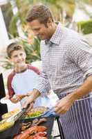 Father And Son Barbequing