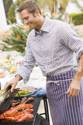 Man Barbequing In A Garden