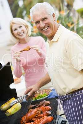 Couple Cooking On A Barbeque