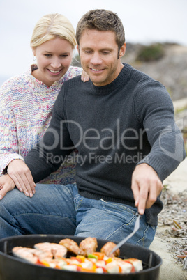 Couple Cooking On A Barbeque