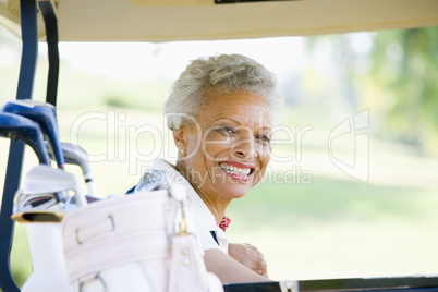 Portrait Of Woman Sitting In A Golf Cart