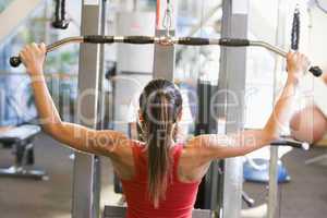 Woman Weight Training At Gym