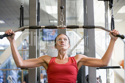 Woman Weight Training At Gym