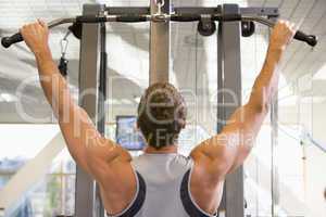 Man Weight Training At Gym